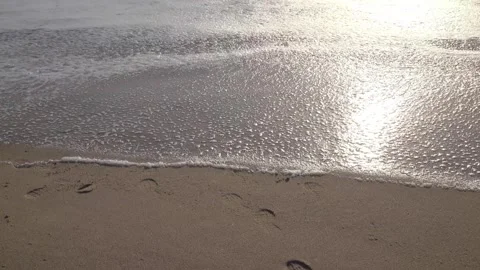 Waves washing away the year 2017 written in sand, captured in 4K Stock Footage 283271483