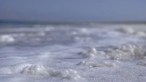 Waves washing over chunks of sea salt Stock Footage 74087971
