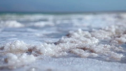 Waves washing over chunks of sea salt Video stock 74087978