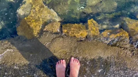 Waves washing over feet Stock Footage 316716984