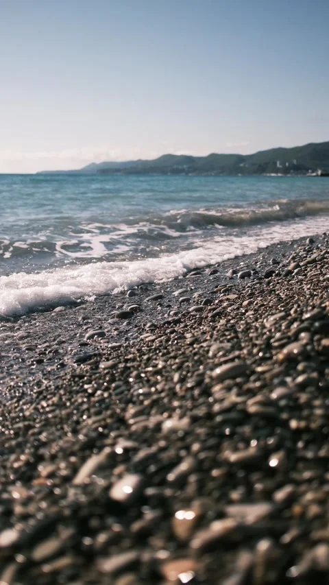 Waves washing over a pebble beach on the Black Sea coast in Russia. Calm seaside Stock Footage 325738179