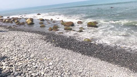 Waves washing over pebble beach shoreline Stock Footage 342044716