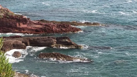 Waves Washing Over Red Ocean Cliffs Stock Footage 334902261