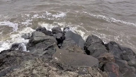 Waves washing over rocks along a rock jetty in New Jersey 動画素材 164049022