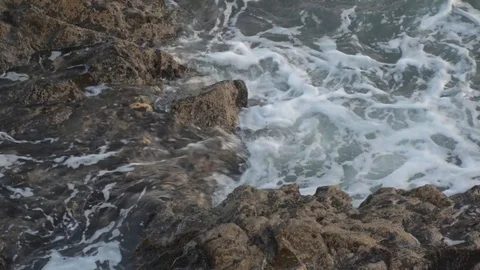 Waves washing over rocks in the evening. Stock Footage 88397889