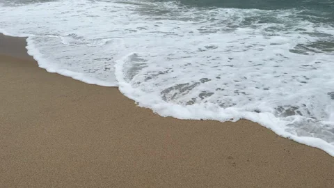 Waves washing over the sand on the empty beach 動画素材 237754860