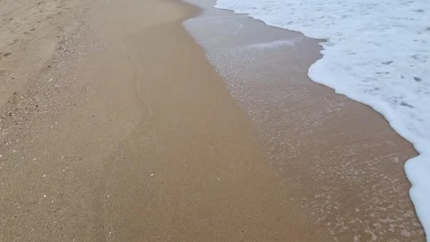 Waves washing over smooth sandy shoreline creating relaxing coastal motion Stock Footage 321651121