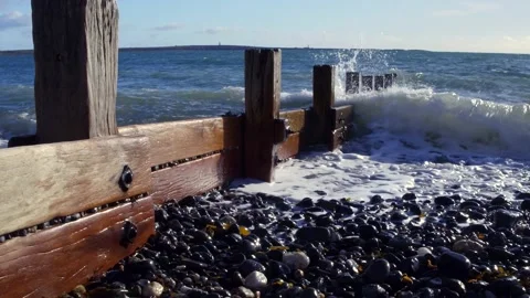 Waves washing up on pebble beach / beach groin Stock Footage 141112295