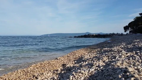 Waves washing the pebble beach Video stock 75826854
