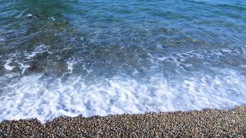Waves washing in on pebble beach Stock Footage 91419230