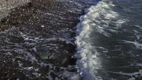 Waves washing up a pebble beach Stock Footage 141112226