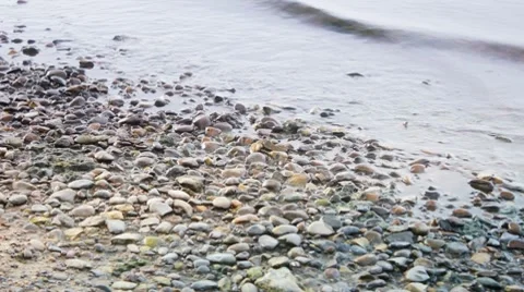 Waves washing pebbles Stock Footage 8520512