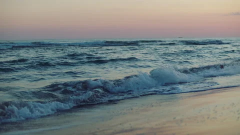 Waves washing sandy beach after sunset 스톡 동영상 155910506