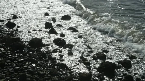 Waves washing onto a sandy beach Stock Footage 54712822