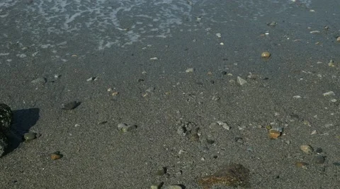 Waves washing onto a sandy beach Stock Footage 54712917