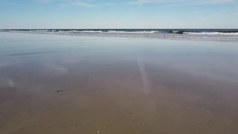 Waves washing up on sandy beach Stock Footage 312062254