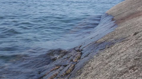 Waves washing on smooth rock Stock Footage 40451227