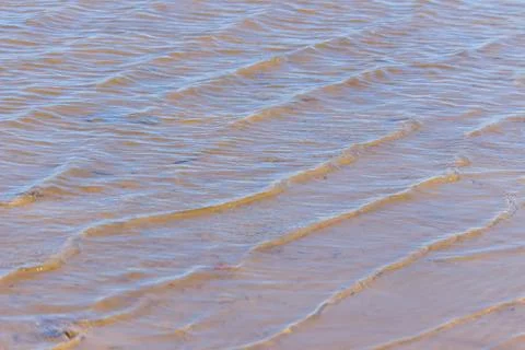 Waves in the water on the sand Stock Photos