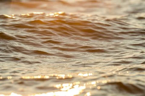 Waves of water sunset background Stock Photos