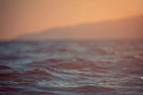 Waves of water sunset background Stock Photos