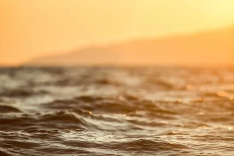Waves of water sunset background Stock Photos