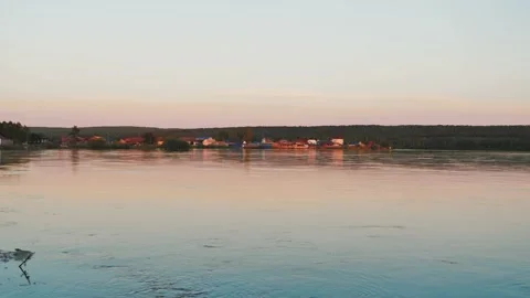 Waves on water surface of river at beautiful soft sunset. River flow at sunset Video stock 185271506