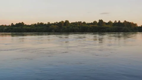 Waves on water surface of river at beautiful soft sunset. River flow at sunset. Stock Footage 185271731