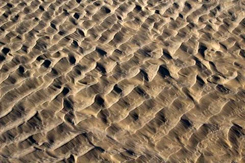 Waves of wet sand Stock Photos