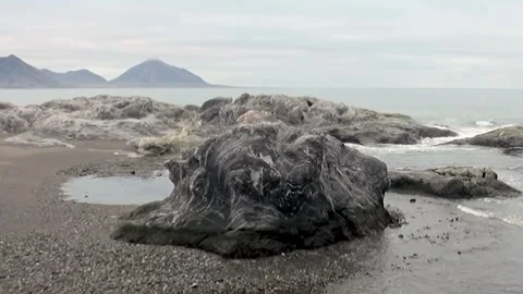 Waves Whisper Ancient Tales on a Rugged Svalbard Shore Stock Footage 340484499