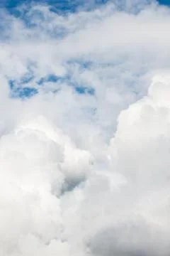 Waves of white fluffy clouds against the blue sky Stock Photos