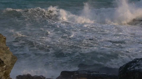 Waves with white foam against the rocks Video stock 35865945