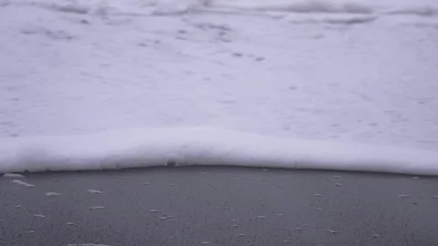 Waves of white foam reach black sand beach at Vik, Iceland at dusk Stock Footage 327082729