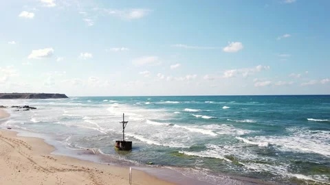 Waves with white foam. Top view. blue sea. Sandy beach with stones, boulders. Stock Footage 139441834