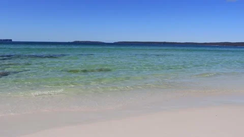 Waves on white sand beach of Jervis bay – slow panorama as 4k. Stock Footage 138290397