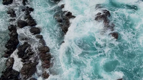 Waves, white sea foam among rocks, ocean close up from above Stock Footage 304270001