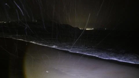 Waves on the winter cold shore of the Barents Sea during the polar night. Stock Photos