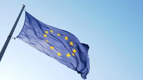 Waving European Union flag in the wind with a blue sky. Slow motion. Stock Footage