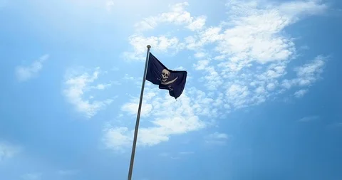 Waving fabric texture of the pirate flag with pole waving in wind, calico jack Stock Footage 124674467