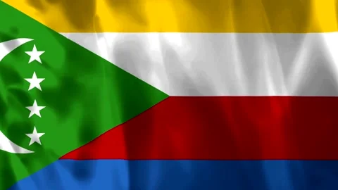 Waving flag of the Comoros featuring green triangle with crescent and four .. Video stock 343583581