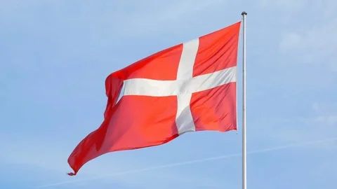 Waving flag of Denmark in background of blue sky Stock Footage