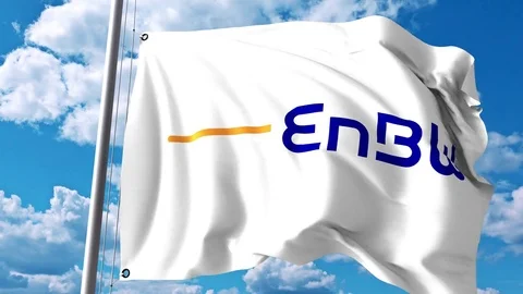 Waving flag with Energie Baden-Wurttemberg AG EnBW logo against clouds and sky Stock Footage