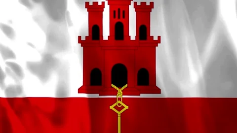 Waving flag of Gibraltar with red castle and golden key design Vídeo Stock 343582584