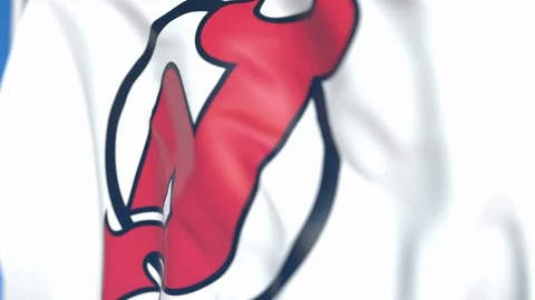Waving flag with New Jersey Devils NHL hockey team logo, close-up. Editorial Stock Footage 114227196