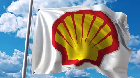 Waving flag with Shell logo against moving clouds. 4K editorial animation Stock Footage 76764978
