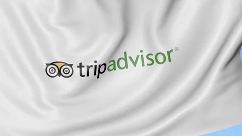Waving flag with TripAdvisor logo, seamless loop. Editorial 4K clip Stock Footage 74407900