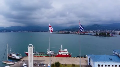 Waving Flags Of Georgia And Adjara Drone View. Port of Batumi In The Black Sea Video stock 169750252