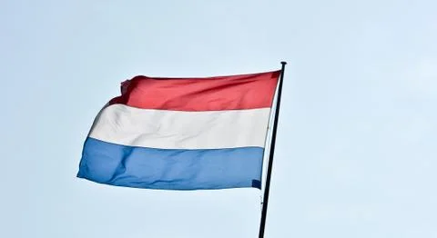Waving flags of Holland against the blue sky Stock Photos