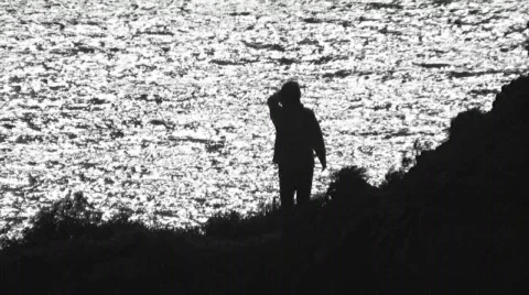 Waving in front of ocean waves Stock Footage 509680