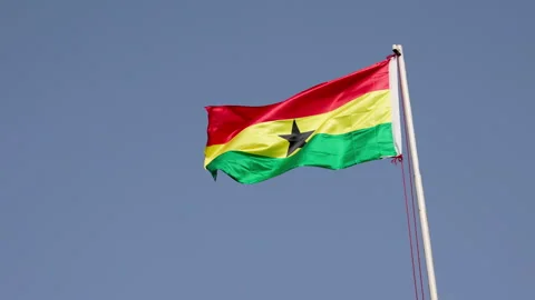 Waving Ghana flags against blue skies on a sunny day. 動画素材 346104465