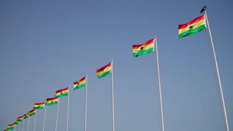 Waving Ghana flags against blue skies on a sunny day. 動画素材 346104480